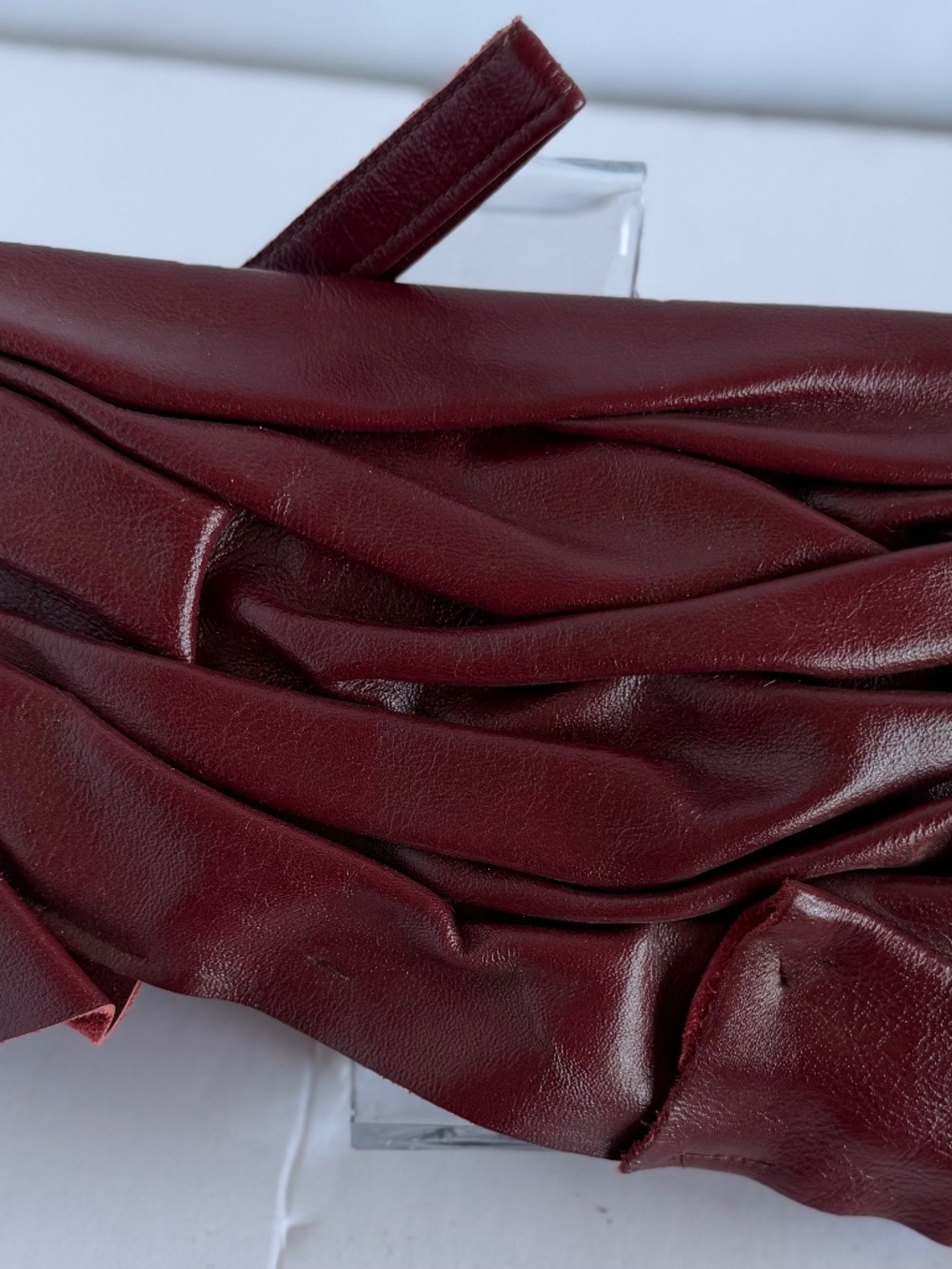 Burgundy Pleated Leather Handbag Featuring a Soft Ruched Design